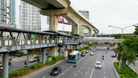 BTS-Skytrain-Monorail-and-Walkway-Below-Over-a-Road-in-Lat-Phrao,-Bangkok