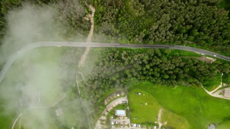 Eagle-eye-view-of-Seiser-Alm-Roadway-through-forest-with-cloud-cover
