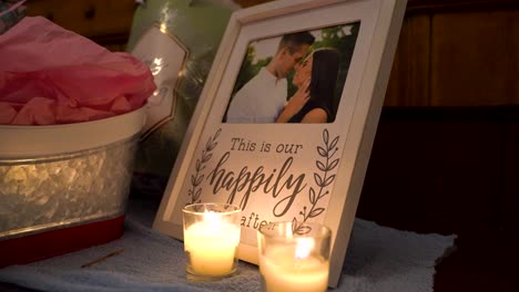 Gorgeous-couple-in-a-picture-frame-behind-some-candles-on-their-wedding-day