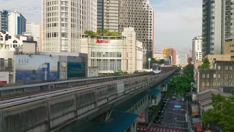 BTS-Asoke-Skytrain-Approaching-Along-Sukhumvit-Road-in-Bangkok-on-a-Clear-Day-in-Thailand