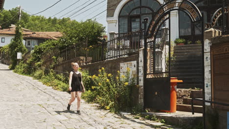 Young-female-summer-tourist-walks-old-streets-of-Veliko-Tarnovo-Bulgaria