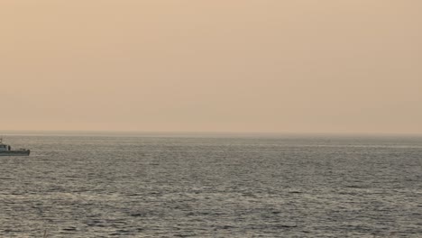 Slow-panning-shot-of-boats-anchored-at-sea-waiting-for-the-airshow-to-start-at-Ayr-Beach