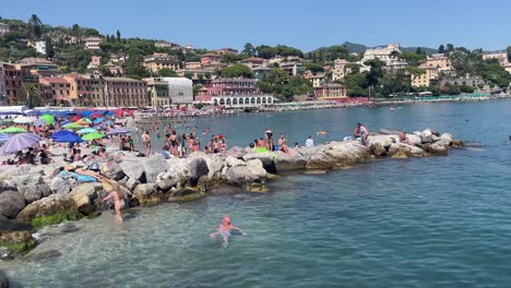 Tourists-sunbath-in-a-charming-beach-in-Santa-Margherita-Ligure,-Italy