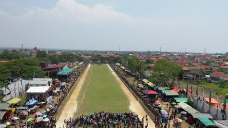 aerial-drone-of-Karapan-Sapi-field-on-Madura-Island-at-Pamekasan-Stadium,-Madura,-Indonesia