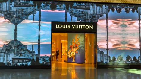 Interesting-creative-Louis-Vuitton-storefront-in-international-airport-in-Istanbul-Turkey,-cool-moving-art,-busy-airport-with-luxury-stores,-4K-shot