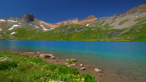 Colorado-Ice-Lake-Basin-trailhead-lower-stunning-bright-blue-alpine-clear-water-summer-blue-sky-Rocky-Mountain-snow-range-peaks-Silverton-Telluride-dreamy-peaceful-wildflowers-slow-pan-left-motion