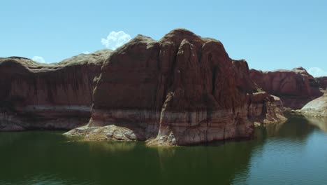 Aerial-Of-Sandstone-Cliffs,-Rock-Formations,-And-Calm-Water-In-Lake-Powell,-Arizona-USA