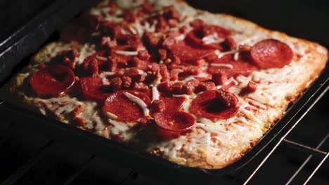 Frozen-pizza-getting-baked-in-the-oven