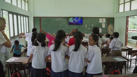 A-full-classroom-full-of-thai-kids-in-school-uniform-dancing-and-happy-in-school