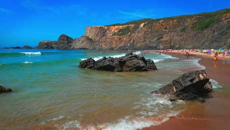 Day-at-the-beach-for-holiday-makers-and-locals-at-Praia-da-Amália-Beach,-Portugal