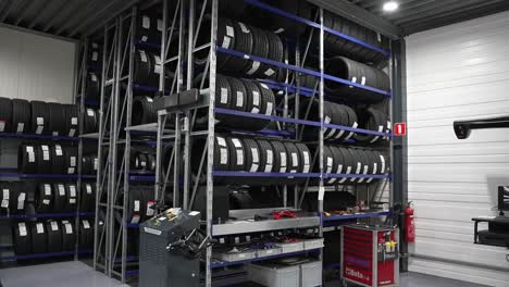 Car-tires-at-the-repair-shop,-stack-of-new-tires-on-a-rack-at-a-warehouse-mechanic