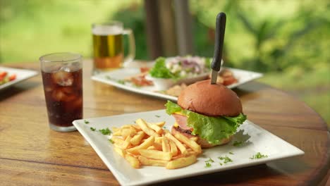 hamburger-with-fries-and-soft-drink,-next-to-ceviche