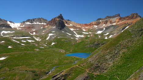 Cinematic-heavenly-paradise-upper-Ice-Island-bright-blue-Lake-Basin-Trail-Alpine-wilderness-stunning-Colorado-Silverton-Telluride-Ouray-Rocky-Mountain-range-snow-summer-beautiful-pan-left-motion