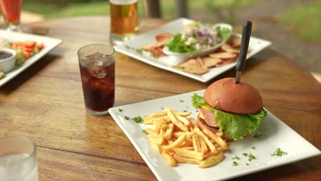 hamburger-with-fries-and-soft-drink,-outside,-together-with-ceviche