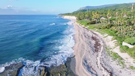 Aerial-forward-flight-over-sandy-beach-with-waves-of-Caribbean-Sea-at-coastline-of-Barahona,-Dominican-Republic