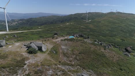 Aerial-View-of-House-in-the-Mountains-with-Windmills