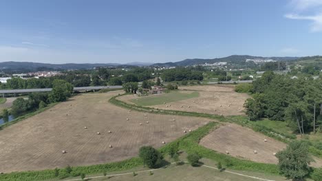 Aerial-View-of-Farmland-with-Hay-Bales-in-the-field
