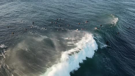 Aerial-view-showing-many-surfer-waiting-for-perfect-wave-in-Australia-during-sunset-time
