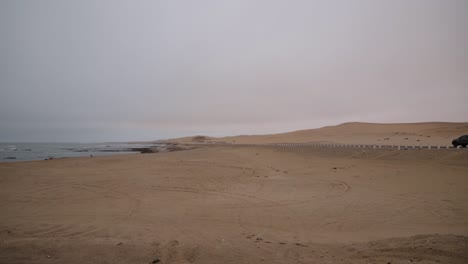 The-national-road-from-Swakopmund-to-Walvisbay-next-to-the-desert-and-ocean-on-a-cloudy-day