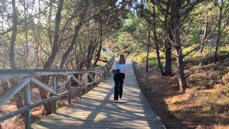 Woman-walking-on-beautiful-mediterranean-path-through-the-forest