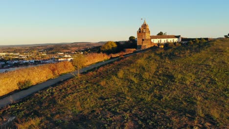 Drone-shot-of-a-medieval-tower-on-a-hill-in-Portugal