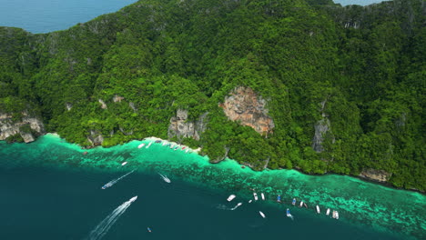An-aerial-shot-taken-high-above-the-mountains-on-Phi-Phi-Islands,-which-are-covered-in-green-forests