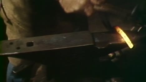 1980S-BLACKSMITH-USING-A-HAMMER-TO-MAKE-A-HORSESHOE-ON-AN-ANVIL