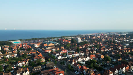 Enjoy-an-aerial-view-of-Skegness,-Lincolnshire,-as-it-comes-alive-with-its-sandy-beach,-tourist-attractions,-and-lively-fairground