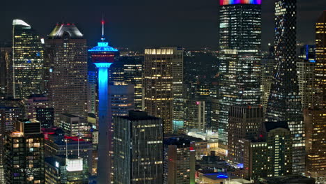 Calgary-AB-Canada-Aerial-v3-establishing-night-hyperlapse-zoomed-3x-capturing-illuminated-downtown-cityscape-with-glowing-and-shimmering-skyscrapers-exteriors---Shot-with-Mavic-3-Pro-Cine---July-2023