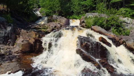 Duchesnay-Falls-in-flow-surrounded-by-lush-green-natural-foliage