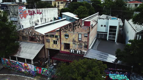 Aerial-tracking-shot-of-graffiti-on-building-walls-in-the-Beco-do-Batman-Alley,-Sao-Paulo,-Brazil