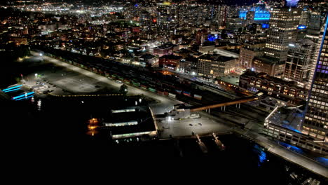Vancouver-BC-Canada-Aerial-v1-hypwerlapse-birds-eye-view,-flyover-harbor-capturing-bustling-downtown-night-cityscape-and-waterfront-illuminated-Canada-Place---Shot-with-Mavic-3-Pro-Cine---July-2023
