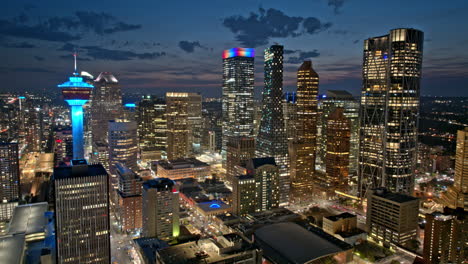 Calgary-AB-Canada-Aerial-v2-dusk-to-night-hyperlapse-capturing-illuminated-downtown-cityscape,-featuring-some-of-the-tallest-skyscrapers-on-the-city-skyline---Shot-with-Mavic-3-Pro-Cine---July-2023