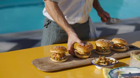 Knife-cutting-burger-on-board-outside