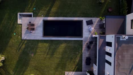 Top-down-aerial-shot-of-a-luxury-villa-with-a-pool-in-Uzès-during-sunset