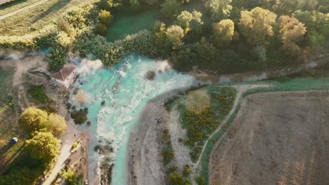 Cascate-del-Mulino,-Soothing-Natural-Hot-Springs-Bath,-Saturnia,-Tuscany,-Italy,-Europe,-Drone-view-traveling-right