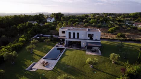 Aerial-revealing-shot-of-a-modern-minimal-mansion-with-a-private-pool-in-Uzes
