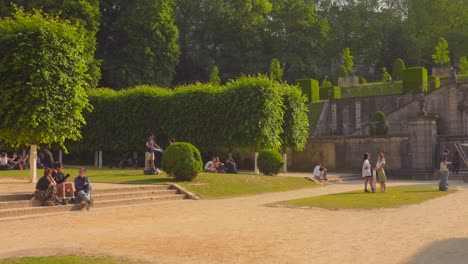 Shot-of-garden-of-college-students-sitting-in-Cumbre-Abbey-,-covered-with-green-vegetation-in-Brussels,-Belgium-on-a-sunny-day