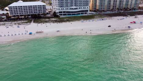 Aerial-view-of-beachfront-resort-hotels-and-condominiums-with-white-sandy-beaches-warm-ocean-waves-Gulf-of-Mexico-USA-Pier-park-Pier-Gulf-of-Mexico-Aerial-view-of-waterfront-hotel-in-Florida