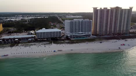 Morning-view-of-beachfront-resort-hotels-and-condominiums-with-white-sandy-beaches-warm-ocean-waves-Gulf-of-Mexico-USA-Pier-park-Pier-Gulf-of-Mexico-Aerial-view-of-waterfront-hotel-in-Florida
