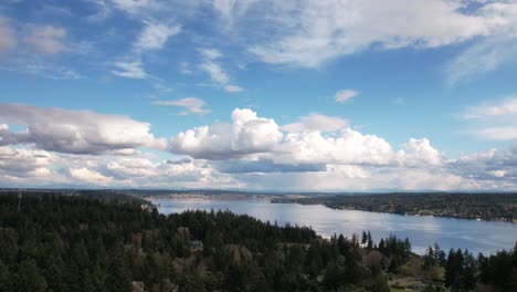 Layers-of-clouds-crisscross-above-the-pristine-waters-of-Puget-Sound,-Tacoma,-Washington,-aerial-hyperlapse
