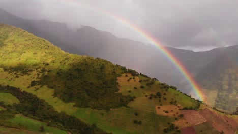 Aerial-View-of-Beautiful-Multicolor-Rainbow-in-the-Sky-Above-Mountain-in-Ecuador