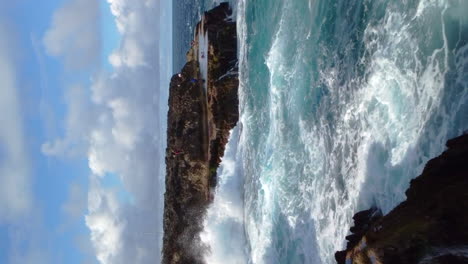 Aerial:-powerful-waves-crashing-against-cliffs,-Lifou-island-New-Caledonia