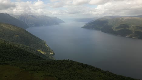 Aerial-of-Sognefjorden,-Norway-with-People-Settling-down-along-a-Mountain-Ridge