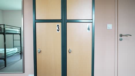 Vertical-panning-shot-of-locker-cabinet-with-numbering-on-compartments
