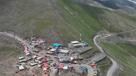 Aerial-View-Over-Mountain-Top-Shops-And-Huts-And-Winding-Road-At-Babusar-Pass