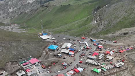 Aerial-Flying-Over-Mountain-Top-Shops-And-Huts-To-Reveal-Winding-Road-At-Babusar-Pass