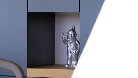 Slow-revealing-shot-of-a-silver-gnome-ornament-gesturing-with-its-hands