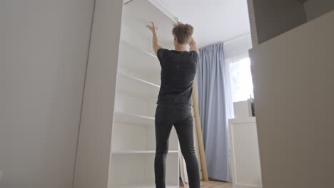 Hands-On-Cabinet-Assembly-Inside-a-Pristine-White-Closet
