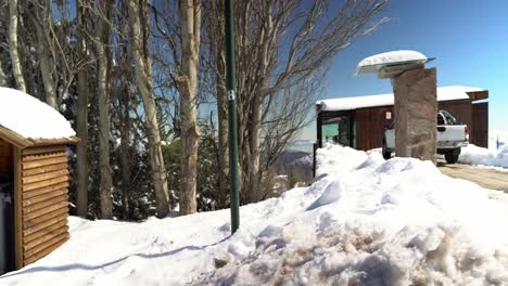 Panoramablick-Auf-Ein-Komplett-Mit-Schnee-Gefülltes-Haus-Und-Eine-Mülldeponie-Mit-Einem-Dach,-Um-Es-Vor-Schneeansammlungen,-Farellones,-Chile-Zu-Schützen